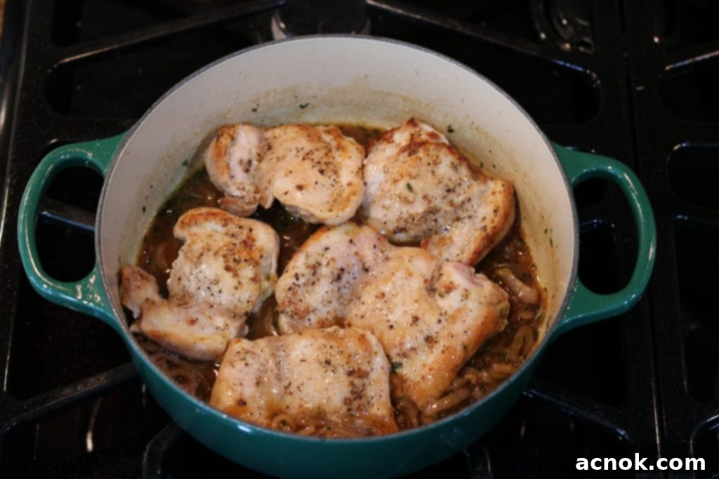Chicken placed back into the shallot fig butter sauce, simmering with lid.