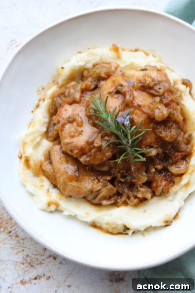 Plated Chicken in Shallot Fig Butter Sauce served with a side dish and napkin.