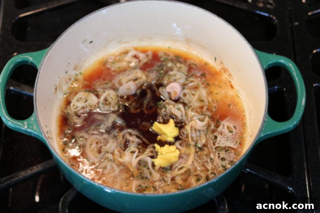 Adding vinegar, water, and chicken concentrate to the pan.