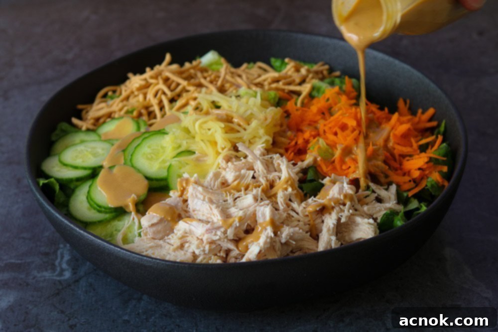 dressing poured onto chinese chicken salad