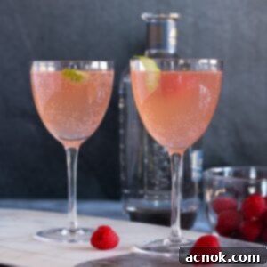 Raspberry Tequila Fizz 6 Sparkling Raspberry Tequila Cocktail in a coupe glass with a raspberry garnish.