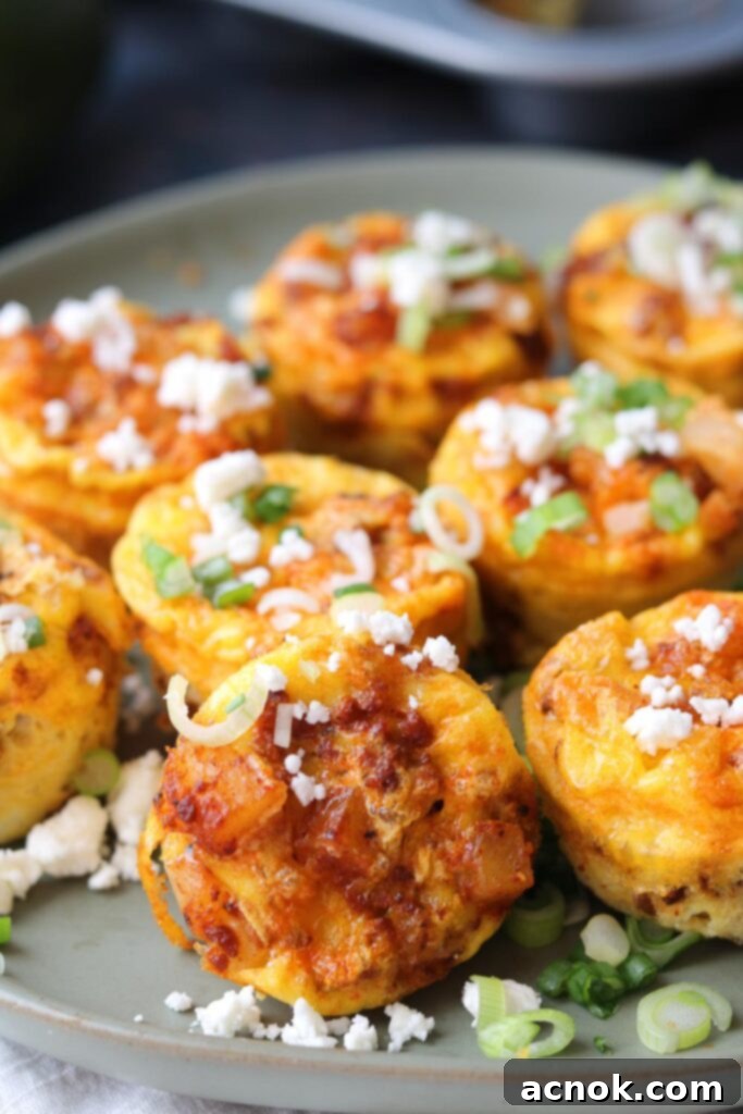 EASY BAKED CHORIZO EGG BITES side view, perfectly golden in a muffin tin