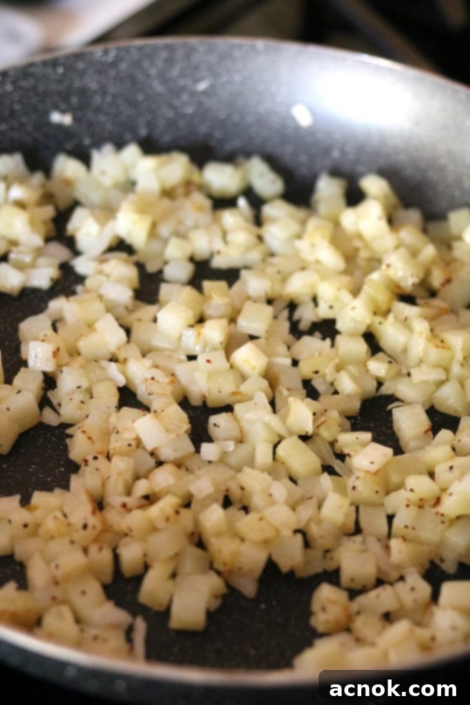 potatoes and onions in skillet cooked, golden brown