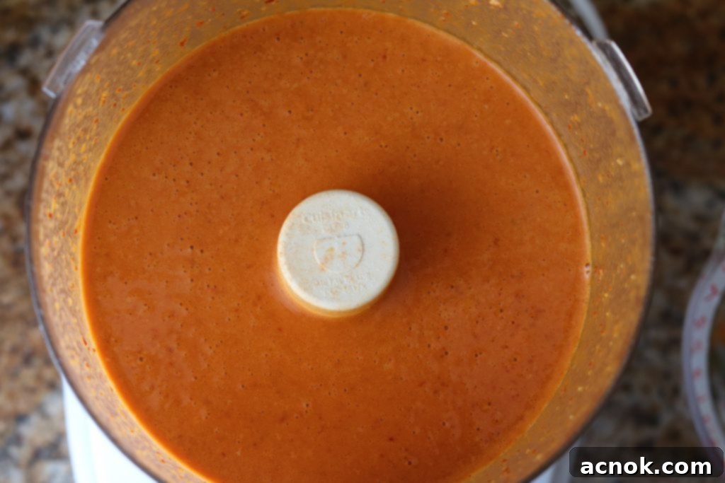 Chipotle agave dressing being pureed in a food processor.