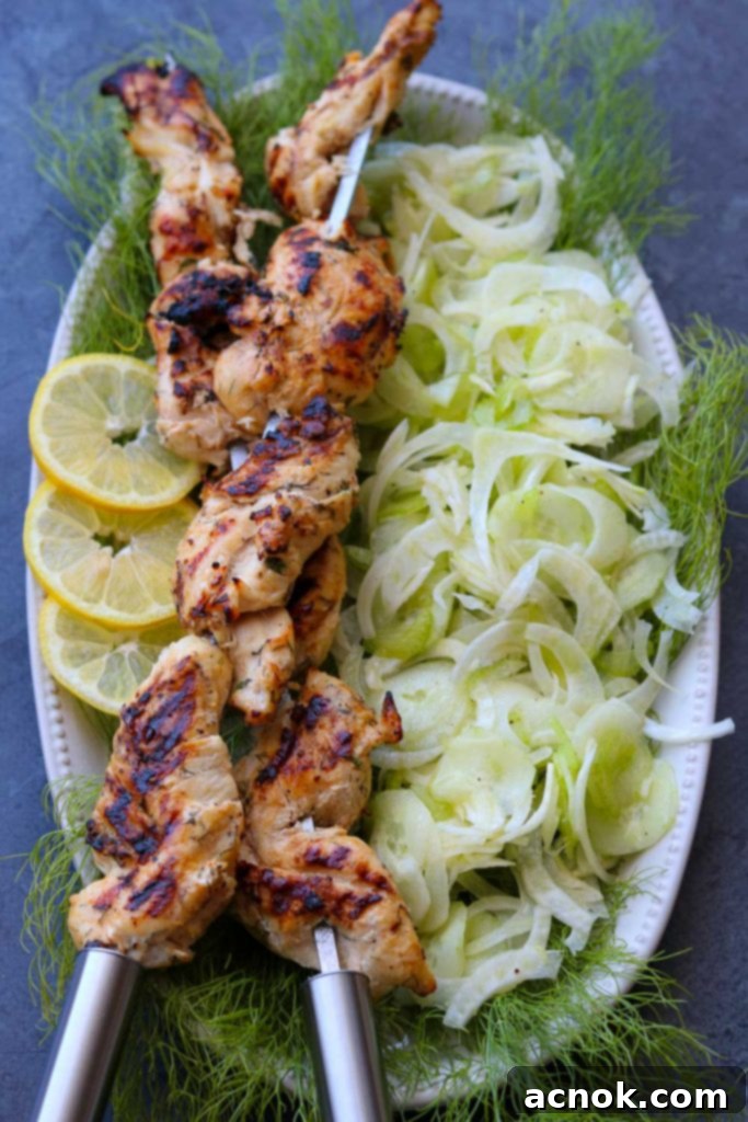 yogurt herb marinated grilled chicken on skewers with shaved fennel salad on platter