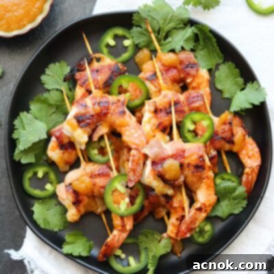 Plated Chutney Glazed Bacon Wrapped Shrimp garnished with cilantro, perfect as an appetizer or main course.