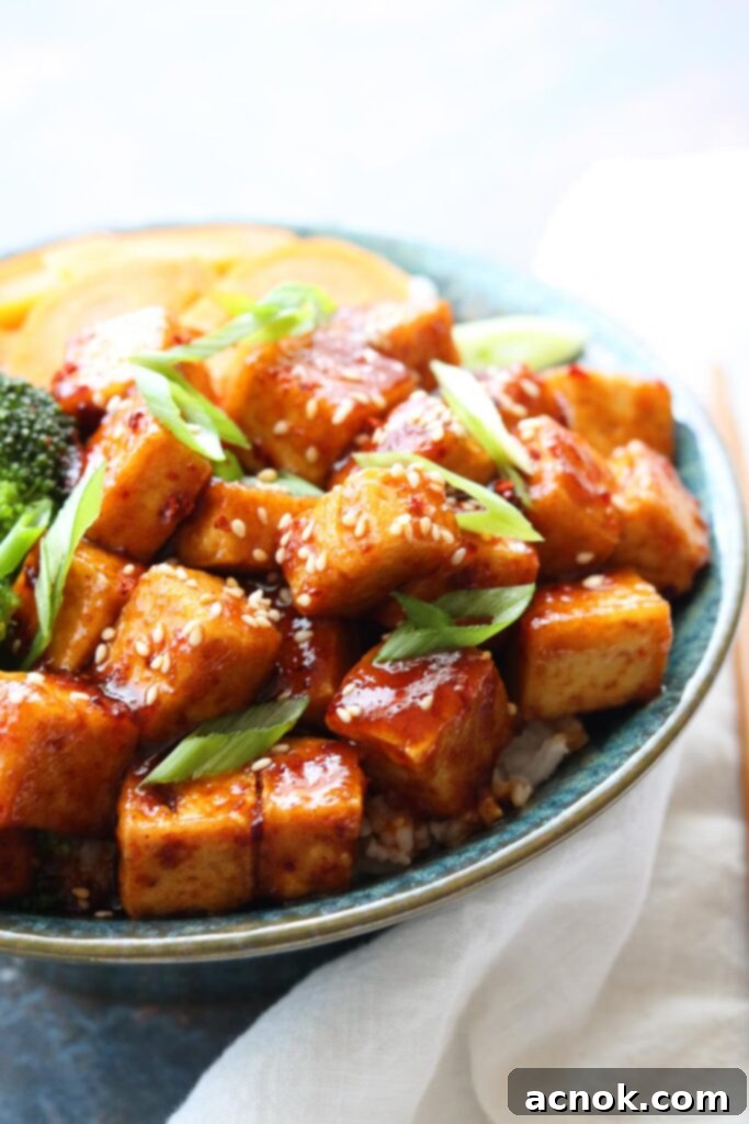 Spicy Korean Style Tofu Bowl with vibrant vegetables and a white napkin