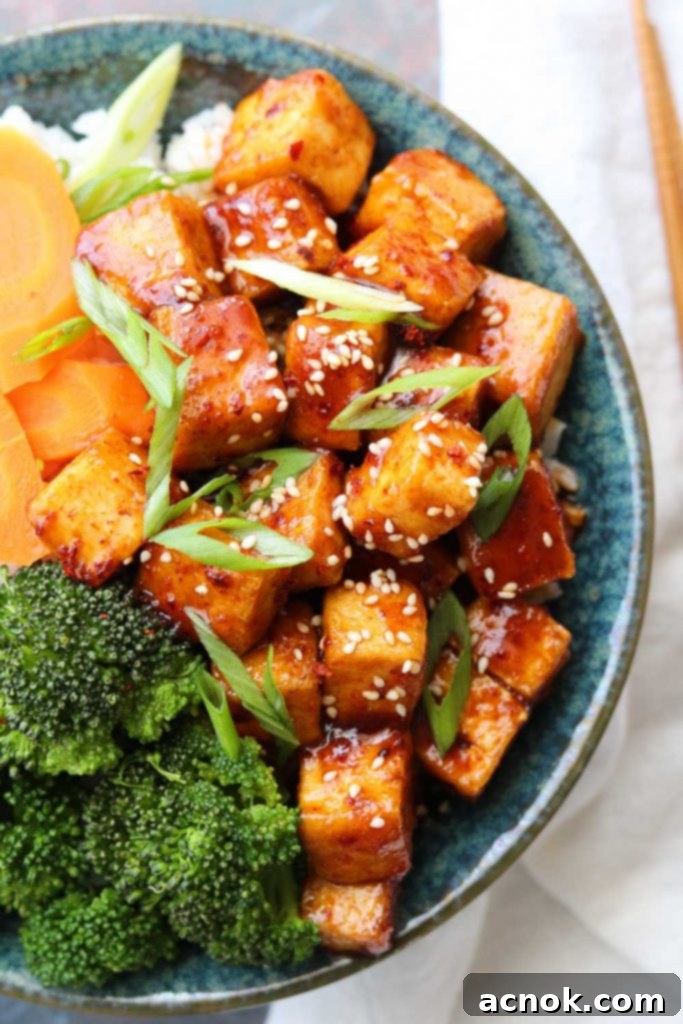 Spicy Korean style tofu bowls served with steamed rice, broccoli, and carrots