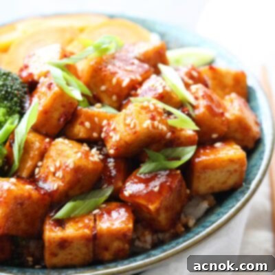 spicy korean style tofu in bowl with veggies and white napkin