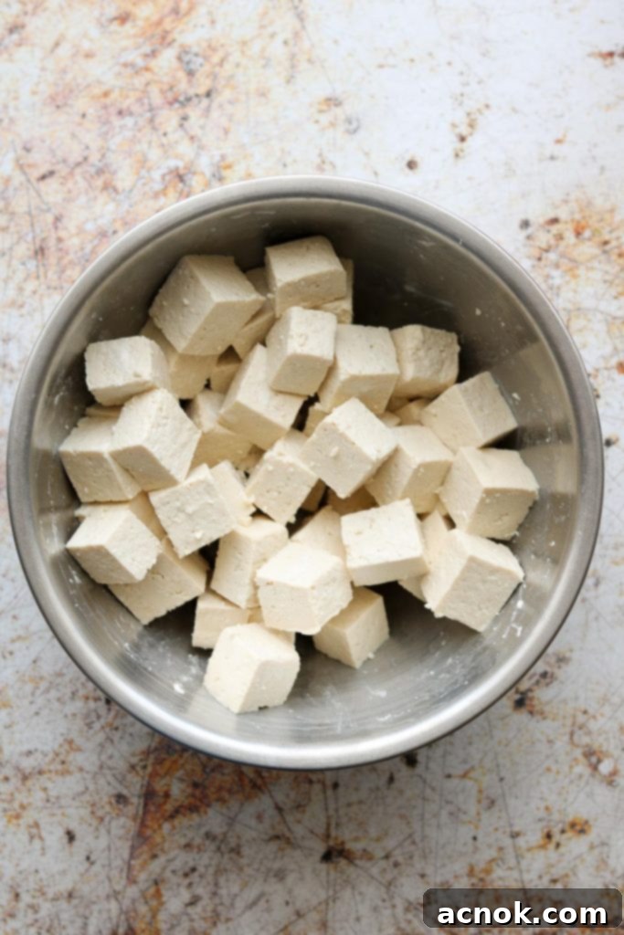 Tossed tofu and cornstarch, ready for frying