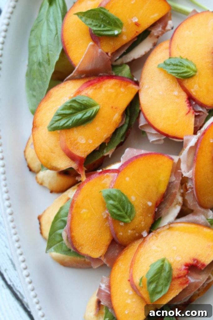 Close-up of a single Peach Prosciutto Mascarpone Crostini, showcasing its fresh ingredients and vibrant colors