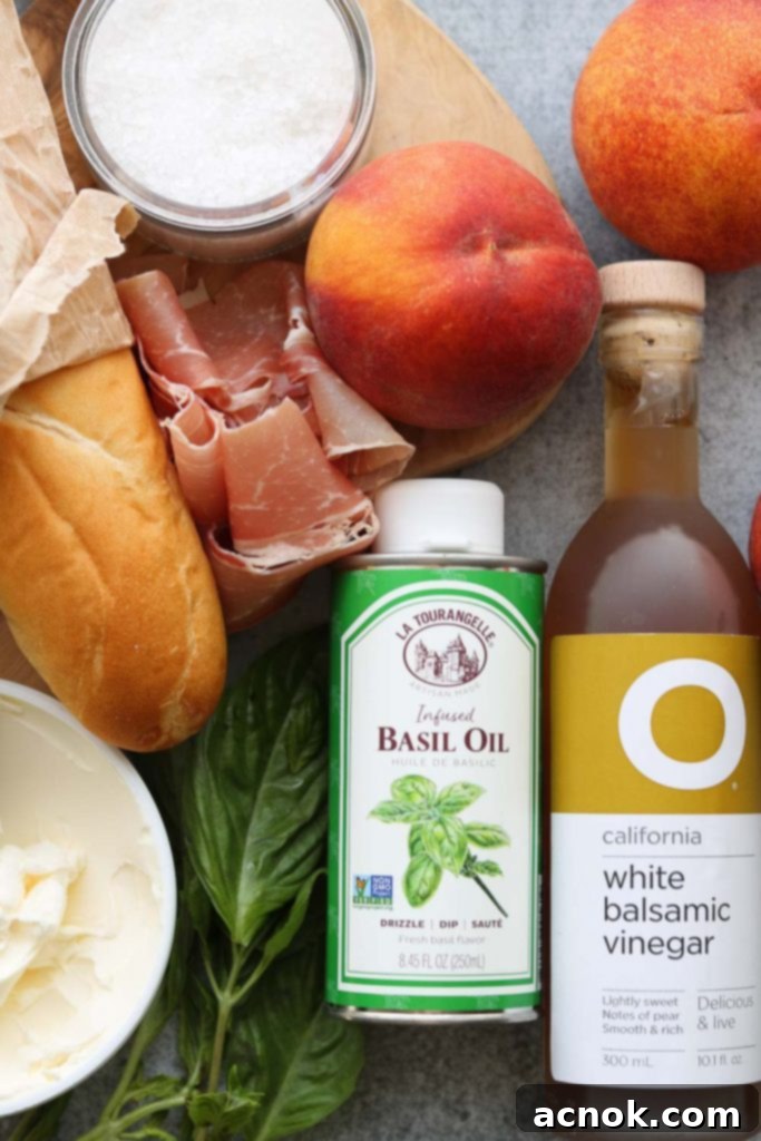 Assortment of fresh ingredients for Peach Prosciutto Mascarpone Crostini, including crusty bread, ripe peaches, mascarpone, prosciutto, fresh basil, basil oil, white balsamic vinegar, and sea salt