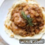 chicken in shallot fig butter sauce plated with napkin