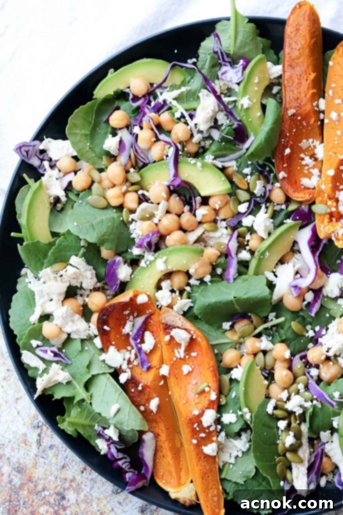 Colorful Superfood Spinach Salad on plate garnished with roasted squash, a healthy and vibrant meal
