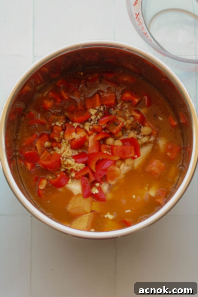 spiced potato and spinach soup in pressure cooker bowl with broth