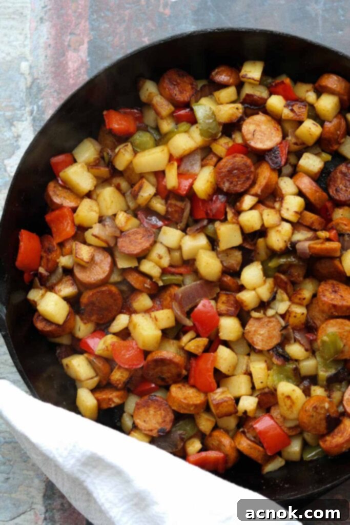 cajun spiced potato hash with sausage in skillet 