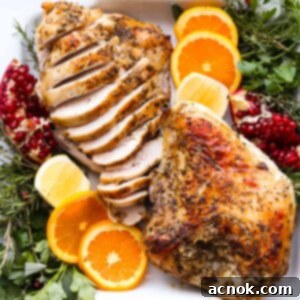 sliced and whole turkey breast with oranges and herbs square image