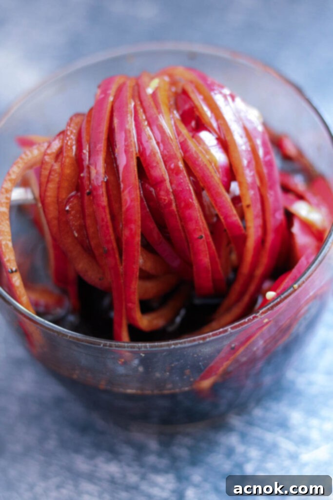 Close-up of vibrant marinated balsamic red onions, glistening and ready to serve.