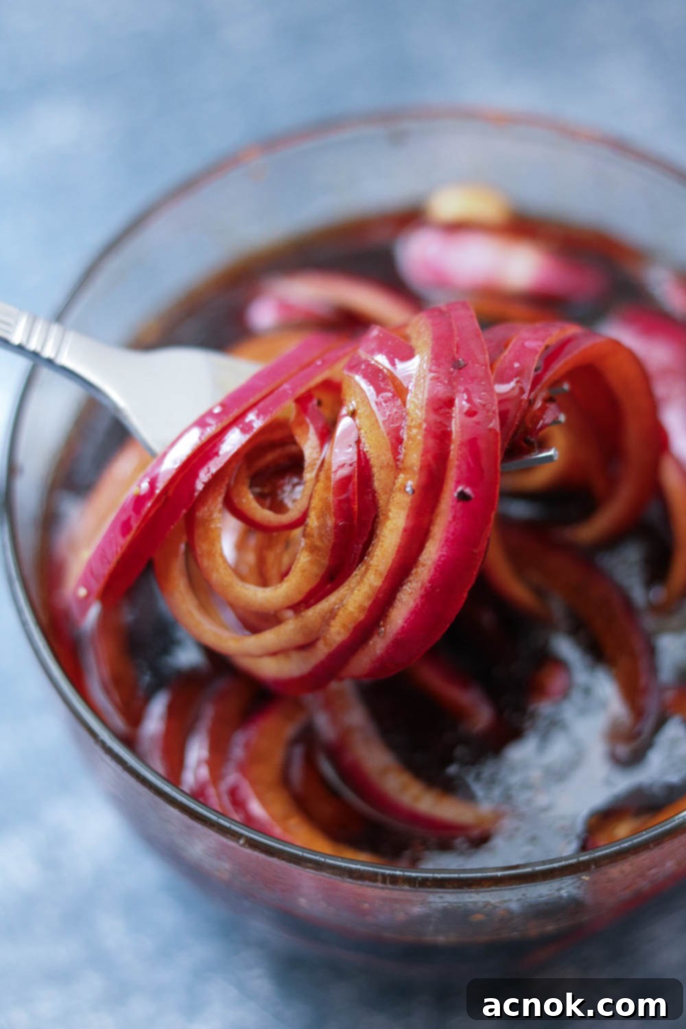 Close-up of finished marinated balsamic red onions in a bowl, showing their softened texture and rich color.