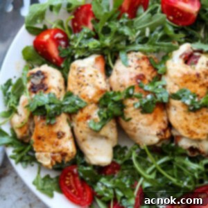 Square image of chicken involtini on platter with arugula salad