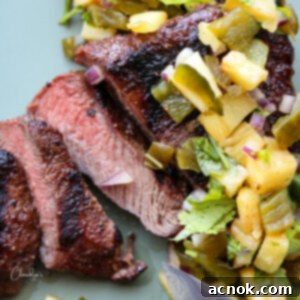 Square image of steak and pineapple salsa