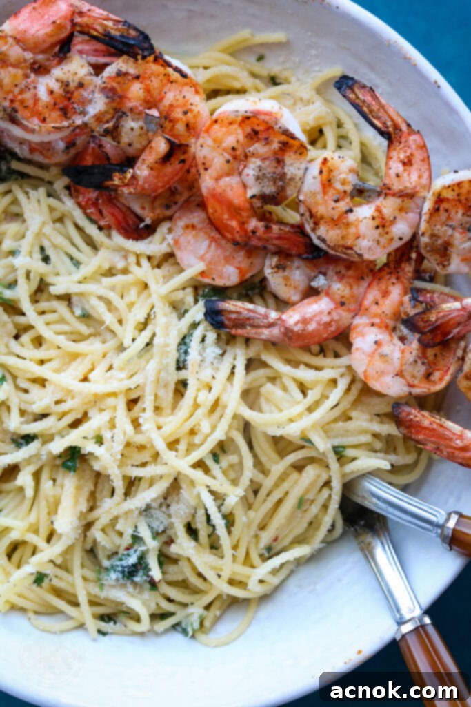close-up of roasted garlic and shrimp spaghetti topped with fresh parsley