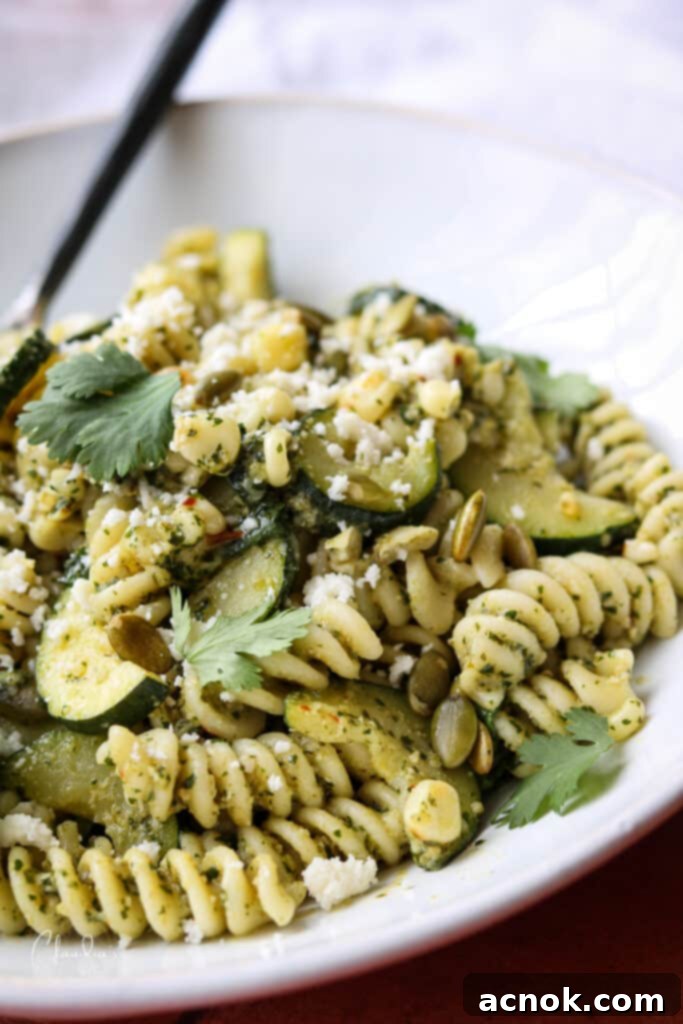 close up of cilantro pesto pasta in white bowl