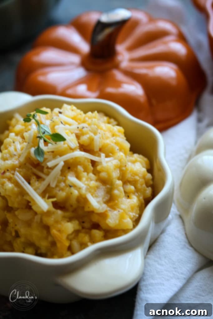 Rich and creamy pumpkin risotto served in a hollowed-out pumpkin bowl, garnished with fresh herbs, perfect for a festive fall meal or Thanksgiving side dish.