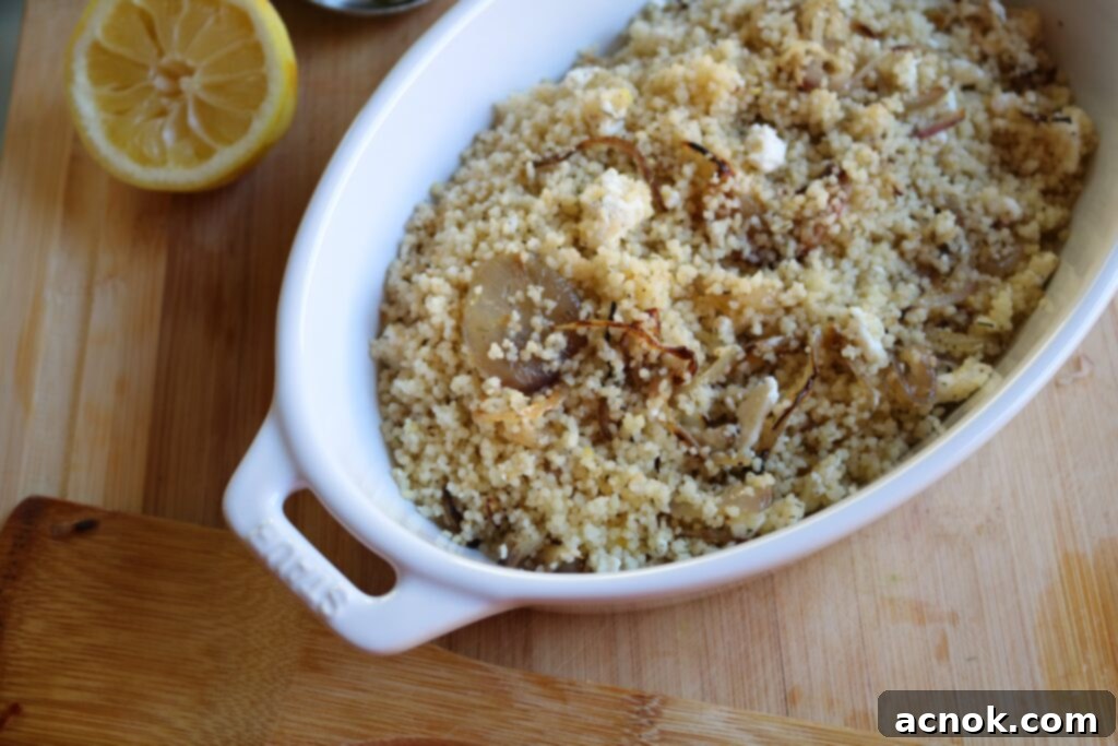 Couscous with Caramelized Onions and Feta, garnished with fresh dill.