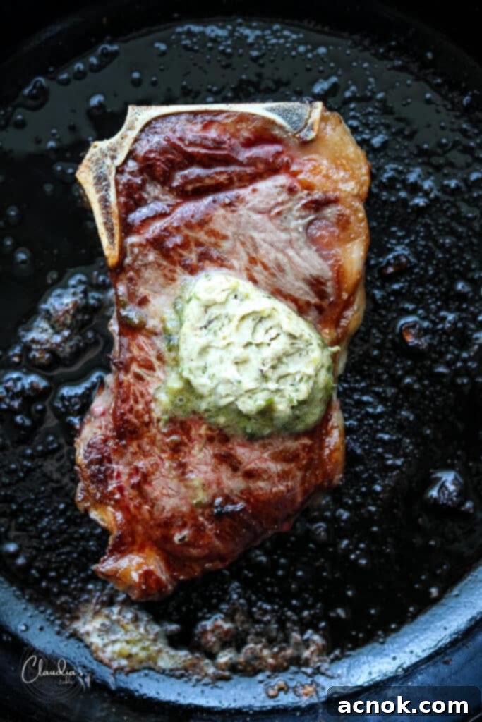 charred scallion butter on steak in cast iron skillet