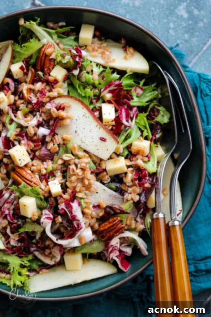radicchio pear salad in green bowl with serving untensils