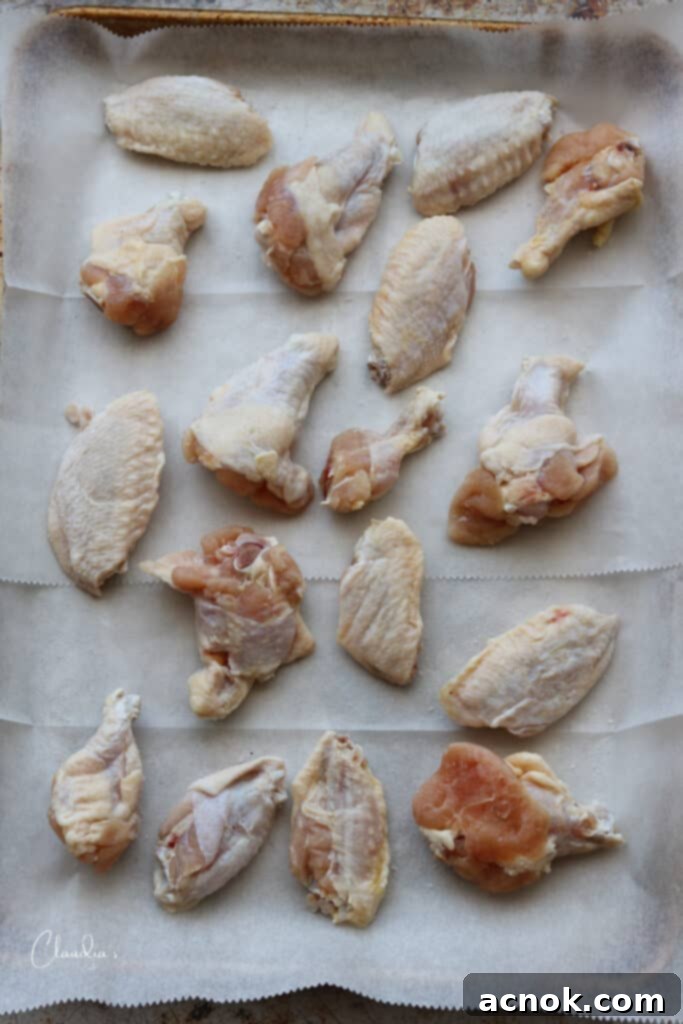 raw chicken wings on baking sheet 