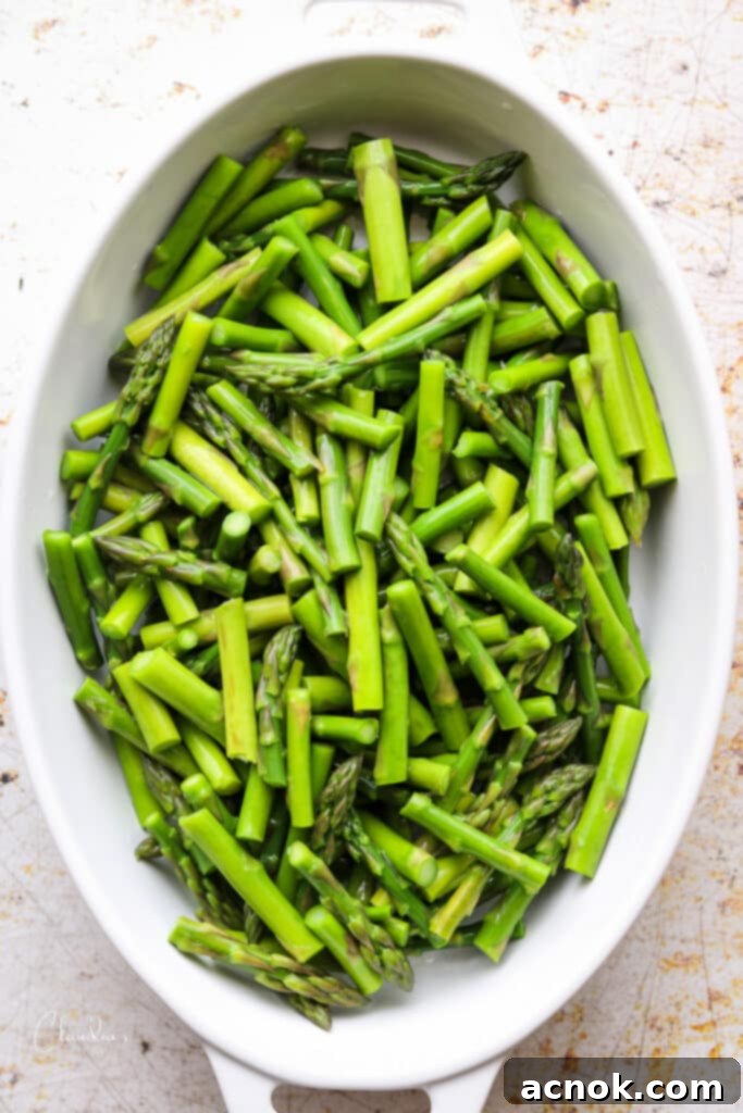 blanched asparagus pieces in casserole dish