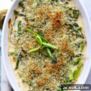 square image of baked asparagus with gruyere cheese sauce