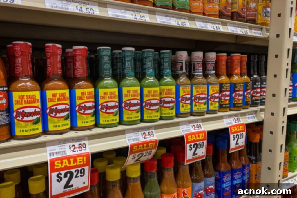 A variety of El Yucateco hot sauces displayed on store shelves, ready for purchase.