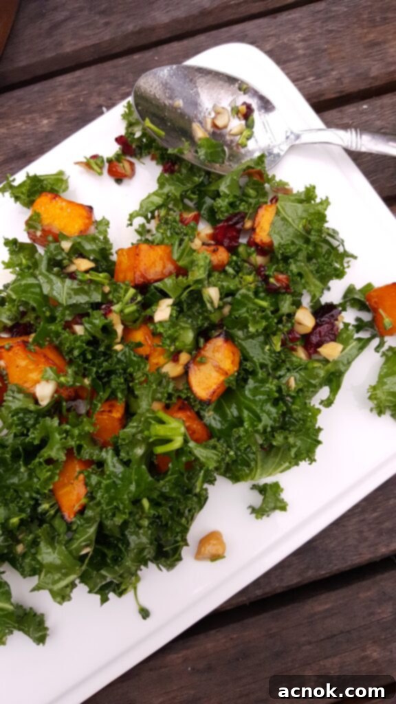 kale broccolini sweet potato salad on white plate with spoon