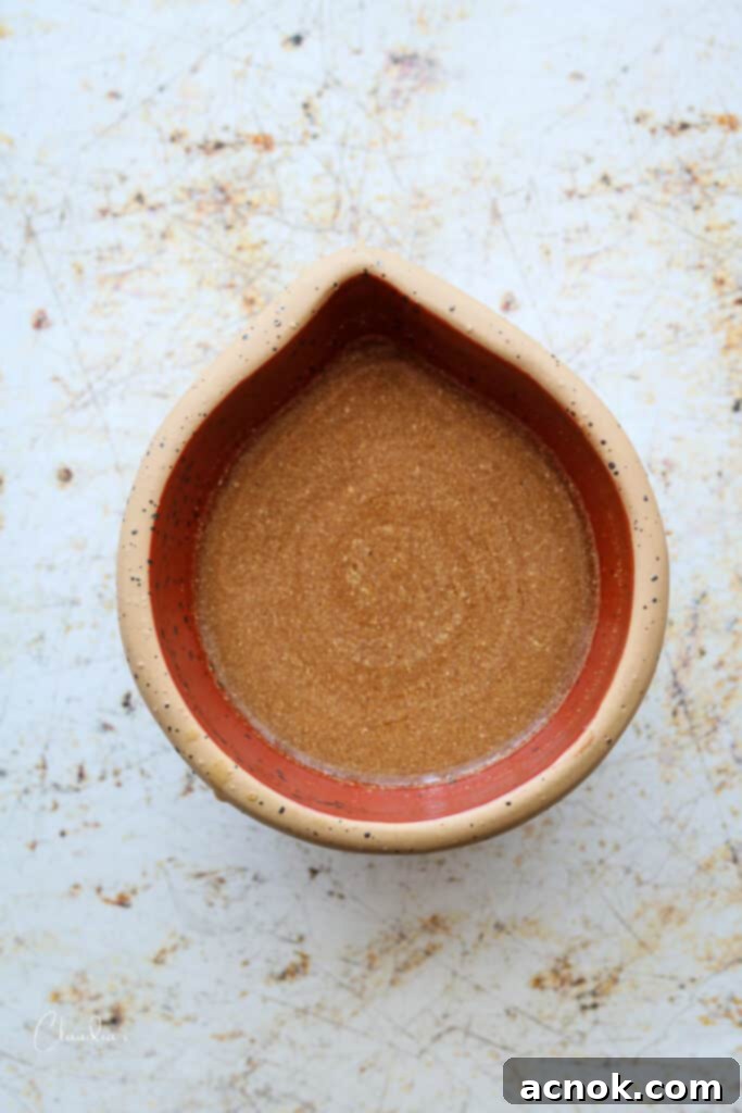 A small bowl containing the mixed cornstarch slurry, the key to thickening the stir-fry sauce.