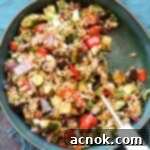 square size balsamic roasted vegetable grain salad with serving spoon