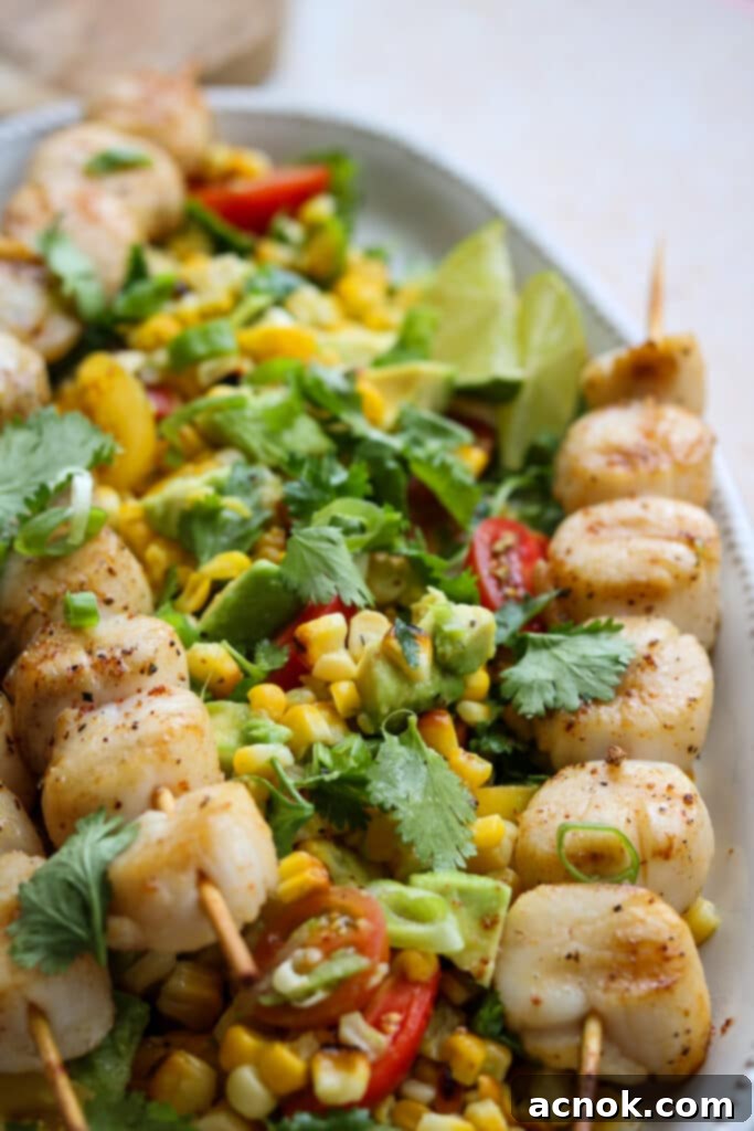 Close up view of spicy scallops corn avocado and tomato salad