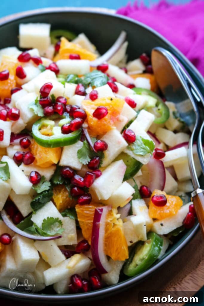 close up of jicama orange salad in green bowl 