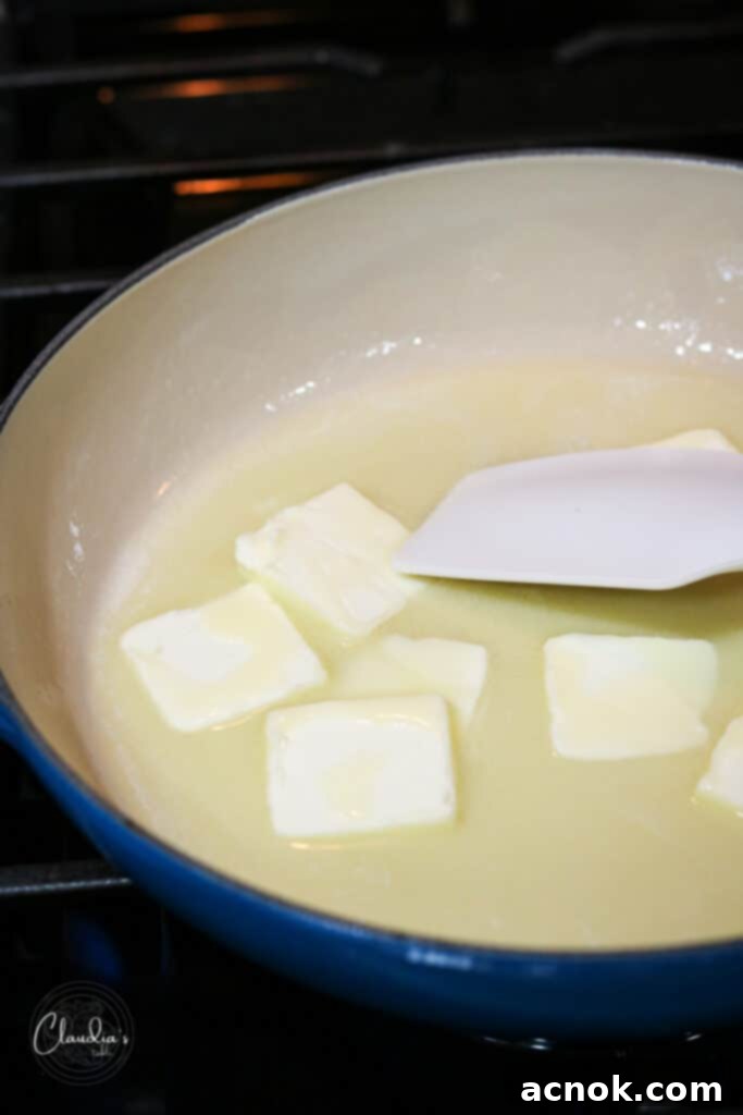 Butter melting gently in a light-colored skillet over medium-low heat.