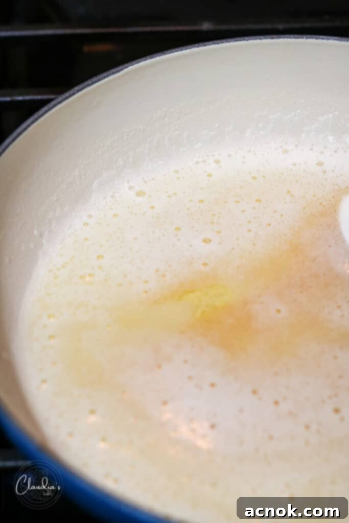 Perfectly browned butter with rich golden liquid and caramelized solids at the bottom, ready to be removed from heat.