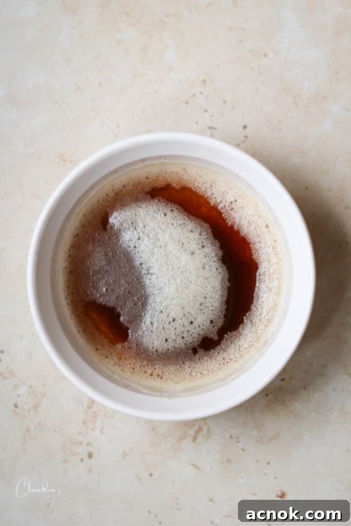 Buerre Noisette, or brown butter, in a clear glass measuring cup, showcasing its rich golden color and clarity.