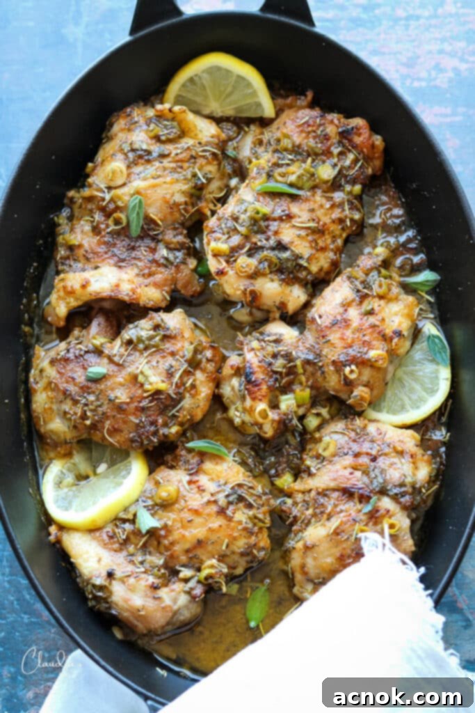 black cast iron pan with chicken thighs ready to be baked