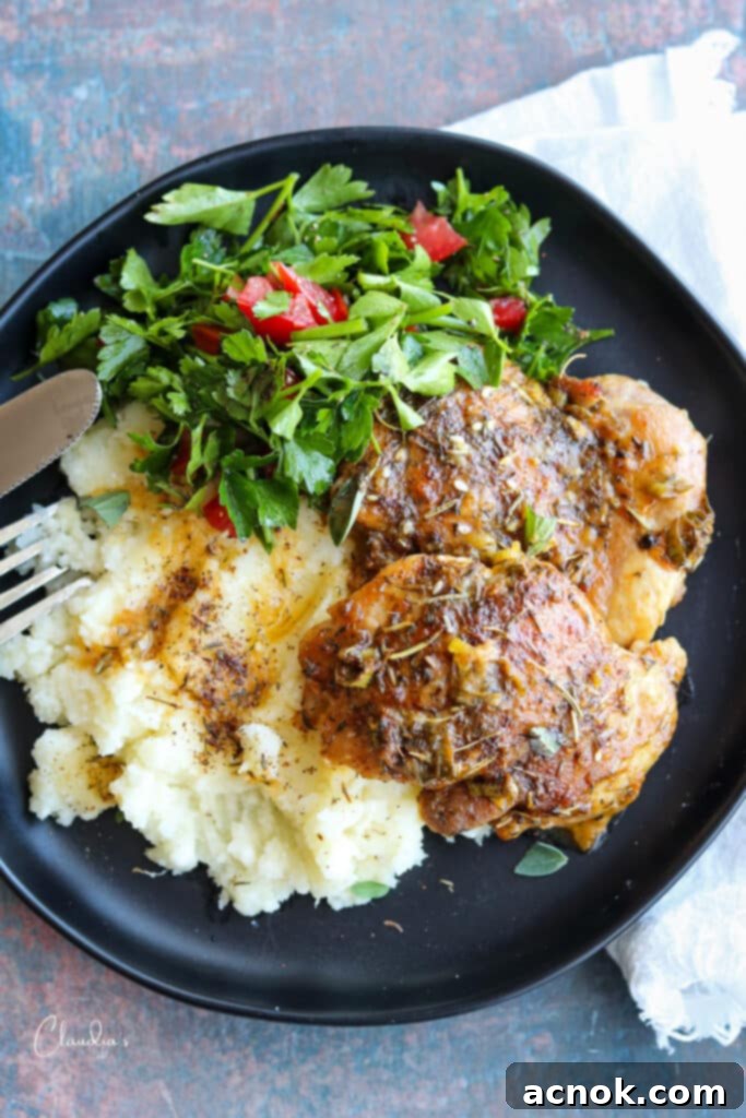 top view chicken with mashed potatoes and salad arranged on a dinner plate
