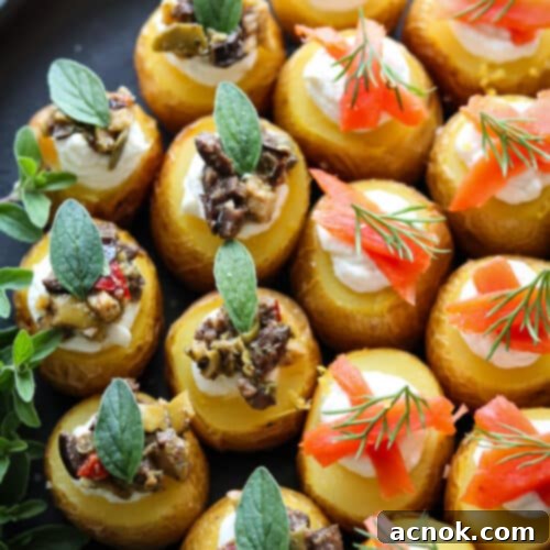 close up of mini stuffed potatoes with smoked salmon and some with olive tapenade. both stuffed with whipped goat cheese.