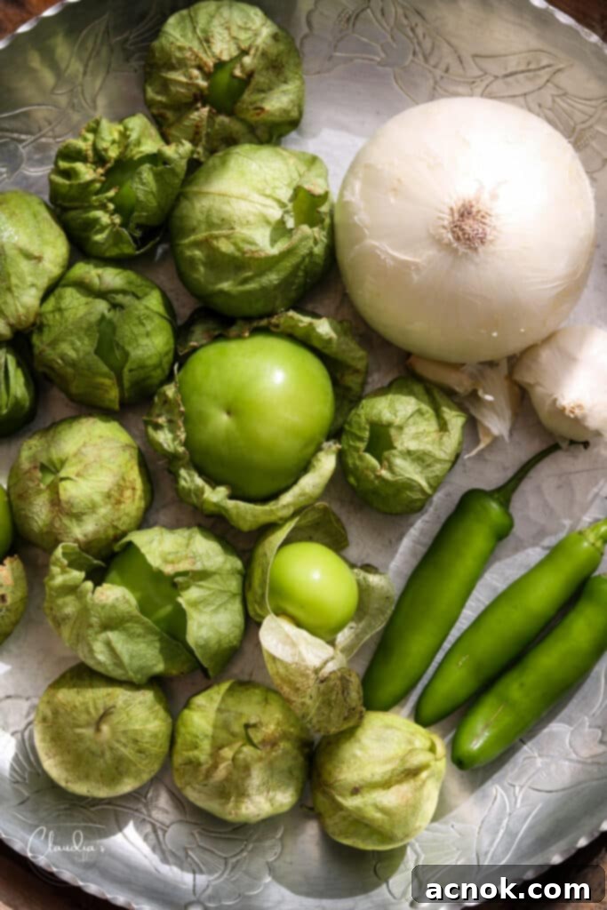 tray with tomatillos, onions, garlic and serrano chiles