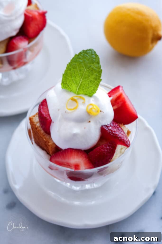 top view of limoncello strawberries with whipped cream, poundcake with lemon zest and mint 