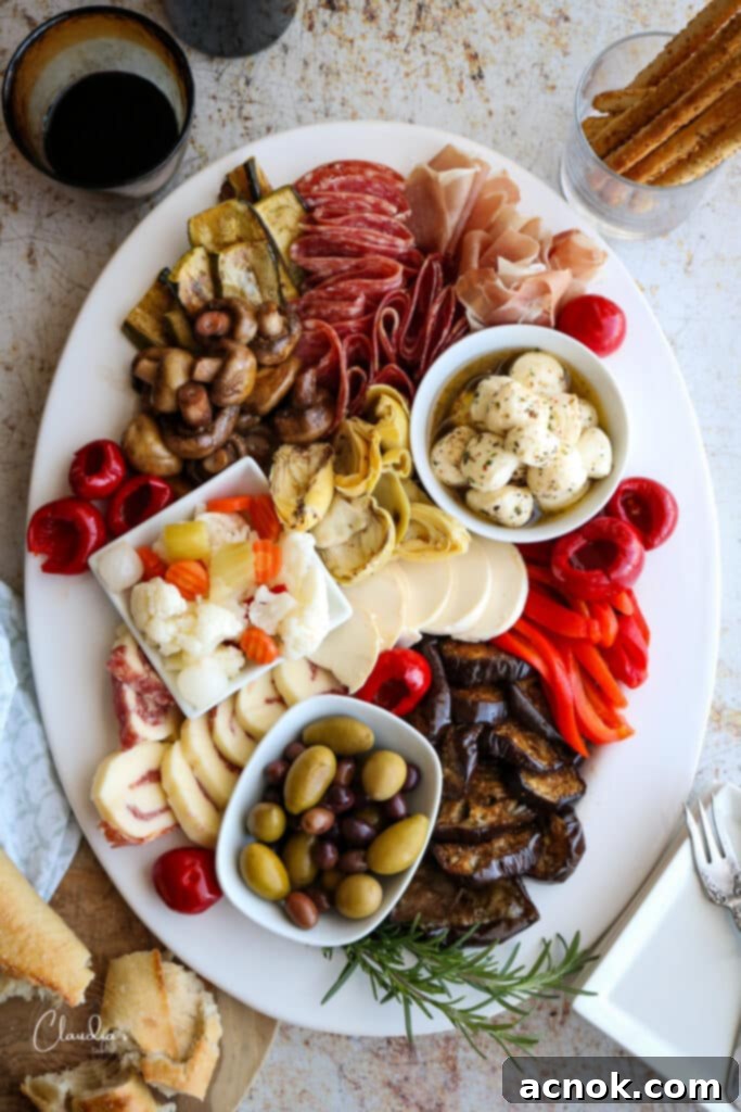 The ultimate antipasto platter with breadsticks and wine