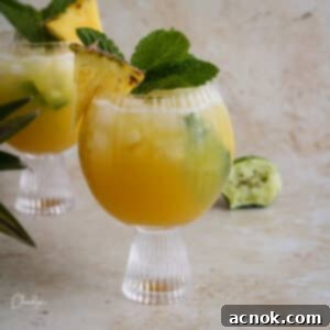 Healthy Tropical Mocktail with fresh mint and pineapple wedge